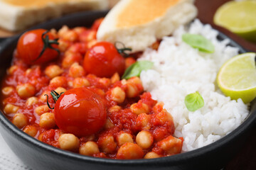 Delicious chickpea curry with rice in bowl, closeup