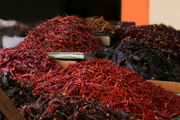 Heap of dried chili peppers on counter at market