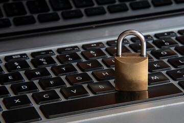 internet and computer security represented by a closed padlock over a black keyboard