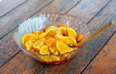 Bowl with sliced oranges and wine before making mulled wine