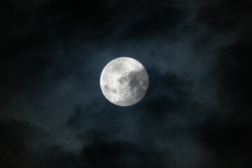 Fototapeta na wymiar Full Moon in September behind clouds