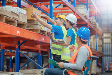 The supervisor is handicapped with a wheelchair inspecting the work background in warehouse.logistic  business export ,Warehouse worker checking packages on store