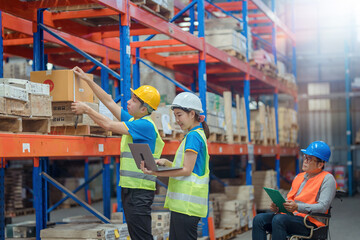 The supervisor is handicapped with a wheelchair inspecting the work background in warehouse.logistic  business export ,Warehouse worker checking packages on store