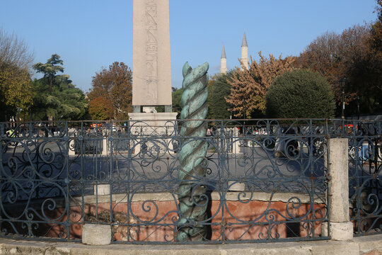 Serpentine Column (Turkish: Yilanlı Sutun) behind Obelisk on Sultanahmet Hippodrome Square at the Eminonu District in Istanbul, Turkey. 