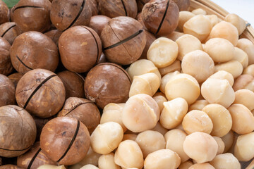 Close up, Macadamia nuts and Macadamia with hard shell on wooden background.