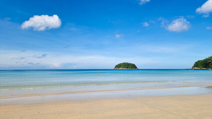 Kata beach Phuket Thailand on a sunny day with a blue sky