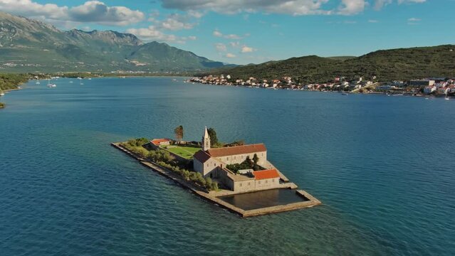 Aerial around view of the island of Notre Dame de la Misericorde, monastery in the Bay of Kotor, Montenegro. Ostrvo Gospa od Milosrda, 4k