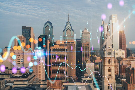 Aerial panoramic cityscape of Philadelphia financial downtown, Pennsylvania, USA. City Hall Clock Tower, sunrise. Forex candlesticks and bar graph hologram. The concept of internet trading, brokerage