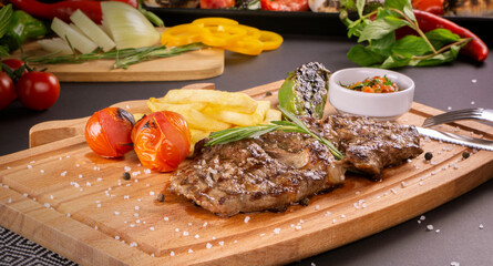 Grilled beef steak on wooden board.