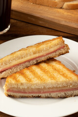 Delicious toasted bread with mortadella and cheese on plate. Selective focus.
