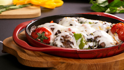 Turkish meatballs with cheese in pan