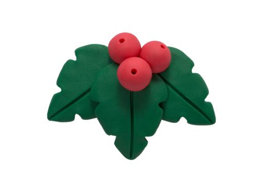Holly berry with leaves made of plasticine. Gingerbread cookie in the shape of a holly berry with leaves, handmade with plasticine. Christmas greeting card concept