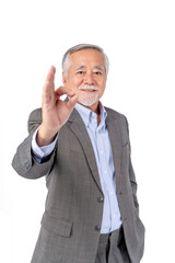 Elderly Man in Suit Making OK Gesture , confidently making an OK gesture with his hand
