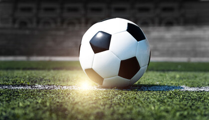 Single soccer ball on stadium grass line