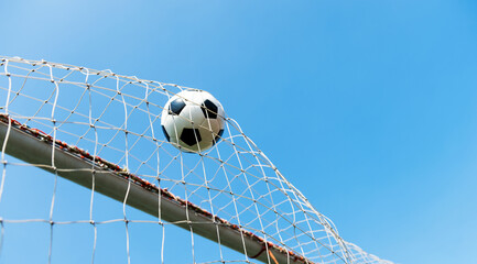 Football goal net against blue sky