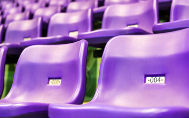 Row of empty purple seats at stadium