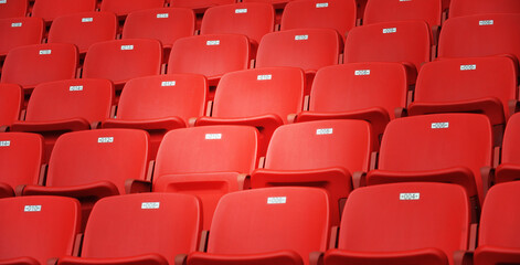 Naklejka premium Row of empty red seats at stadium