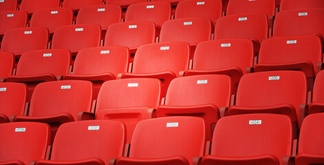 Row of empty red seats at stadium