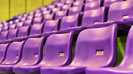 Fototapeta premium Row of empty purple seats at stadium