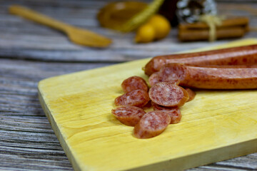 Chinese Sausage bright red cut into small pieces on the chopping board to prepare cooking.