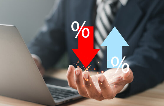Businessman showing percentage icons and up and down arrow icons with graph indicators. Concept of financial interest rates and mortgage rates.  Interest Rates Stocks Finance Ratings Mortgage Rates.