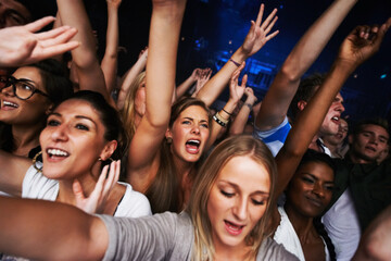 Crowd, concert selfie and music festival with fans having fun, audience cheers for live band performance in Los Angeles. Music, energy and entertainment with excited picture and festival for new year