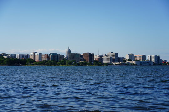 City landscape photo of Madison, Wisconsin capitol and city buildings from Olin park