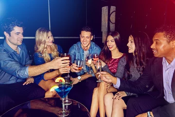 Toast, cocktail with friends in nightclub, party and celebrate new year with alcohol drinks and fun together in club. Cheers, celebration and holiday with friend group and drinking cocktails. © Grady R/peopleimages.com