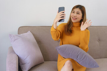 Work from home concept, Businesswoman using smartphone to video call and greeting with colleague