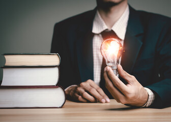 Businessman holding a light bulb think problem solving. business competition planning...