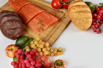 Salmon and fruits on the table as background.