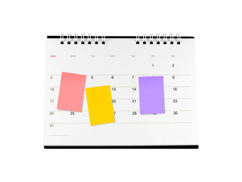 three colourful sticky notes on cardboard desk calendar page with date isolated on transparent, monthly business deadline planning or event reminder schedule