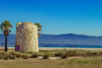 Spanish Tower and palms on Poetto beach. Cagliari, Sardinia, Italy