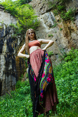 Fototapeta na wymiar Beautiful girl with dreadlocks, dressed hippie style,poses outdoors.