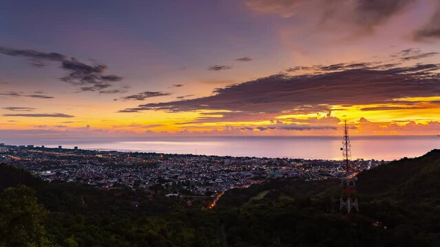Beautiful night to day 4k timelapse shot of Hua Hin City and mountain with colorful clouds movement and sunrise.