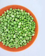 Green pigeon pea beans isolated on background, Green Toor Dal in orange bowl