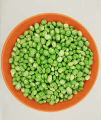 Green pigeon pea beans isolated on background, Green Toor Dal in orange bowl