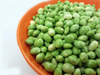 Green pigeon pea beans isolated on background, Green Toor Dal in orange bowl