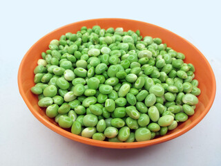 Green pigeon pea beans isolated on background, Green Toor Dal in orange bowl