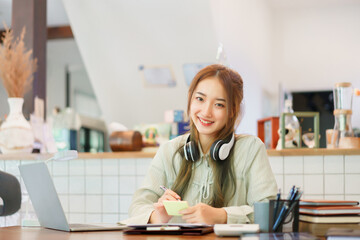 Business concept, Woman entrepreneur writing idea in post it notes while working in coworking space