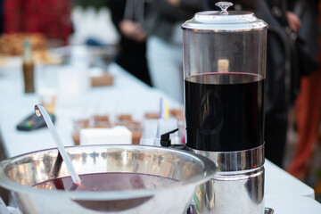 hot wine in a bowl at a fair on the street, Christmas mulled wine, a festive drink