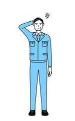 困って頭をかく作業着を着た男性（経営者、管理職、工場長）