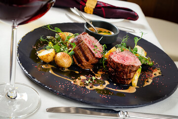 steak with baked potato and sauce