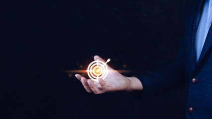 Targeting concept with businessman hand holding digital image of dartboard,Businessman holding virtual dartboard and arrow with copy space for setup business objective target concept.