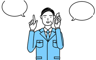 電話をしながら指さしをする作業着を着た男性（経営者、管理職、工場長）