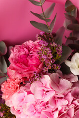 Beautiful bouquet of chamelaucium uncinatum, fresh roses, carnation, freesias, hydrangea, eucalyptus in tender pink and white colors, bouquet of flowers close up. Floral shop concept.