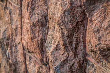 The wall is finished with roughly processed granite stone