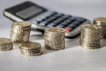 Money in the bank on a table with a white tablecloth and lighting from the window