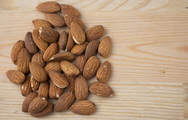 Roasted almonds on wooden background