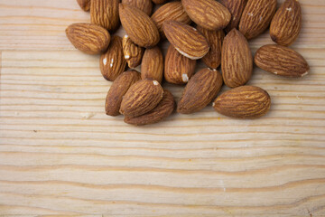 Roasted almonds on wooden background